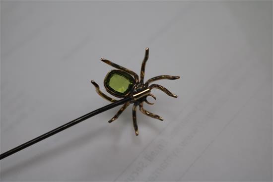 A yellow metal and gem set spider hat pin in original box, 17cm.